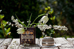 Snake's head fritillaries and branches of blackthorn blossom in old tin