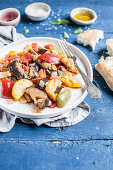 French Ratatouille made with bell peppers, eggplant, yellow courgette, onion and garlic, served with fougasse