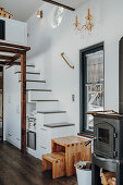 Stools at foot of staircase with integrated storage space in tiny house