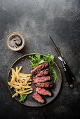 Grilled t-bone steak with rocket and chips