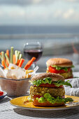 Homemade healthy vegan green lentil burger with tomato, lettuce and french fries