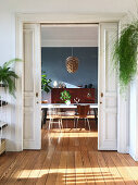 View through open sliding doors into vintage-style dining room