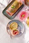 Strawberry and pistachio roulade on a garden table