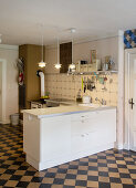 White furnishings and cement tiles in kitchen-dining room