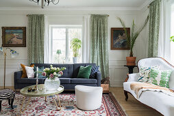 Classic, elegant living room with panelled walls in period building