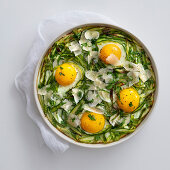Bread and asparagus bake with parmesan and fried eggs