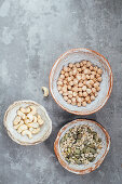 Seed mix, chickpeas and cashews in hand made clay bowls