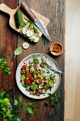 Lentil salad with cucumber, tomato, pesto and baby spinach