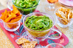 Pea hummus with nachos and crackers