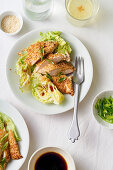 Sesame chicken with lettuce wedges and honey dressing