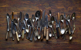 Old cutlery on a wooden background