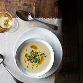 Cauliflower soup with garnish of fried cauliflower florets, olive oil and parsley