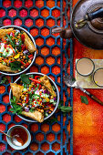 Chaat salad (spicy chickpea salad, India) with samosas and peanuts