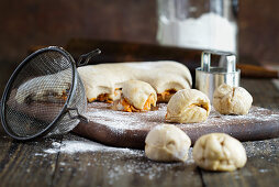 Little balls of Carrot Cake Monkey Bread dough being cut out for baking