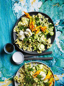 Farfalle with zucchini flowers, goat's curd and herbs