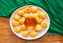 Cheese Puffs, served with honey being prepared