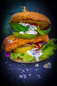 A fish burger with green tomatoes