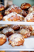 Sweet puff pastries with flaked almonds in a bakery