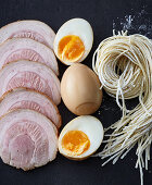 Typical ramen ingredients – chashu, pickled eggs and noodles