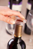 Foil being removed from a bottle of red wine