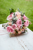 Festive bouquet with roses, lilies of the valley, Lamb's-ear, and purple bells