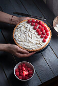 Coconut tart with coconut chips and raspberries