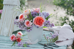 Small bouquet of roses and lilacs, flowering twig of thyme and scissors