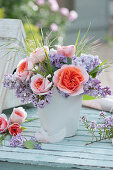 Small bouquet of roses and lilacs, flowering thyme branch