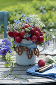 Edible bouquet made from radishes, borage and beaver nelle, decorated with pretzels