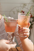 Pink fizz with rosemary sprigs