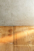 Wooden table in front of a concrete wall