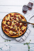 Baked pizza with ratatouille and vegan cheese