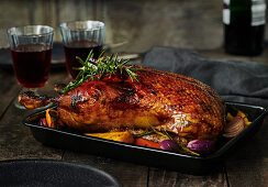 Crispy roast duck in a black baking dish