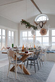 Set table in Scandinavian-style conservatory decorated for Christmas