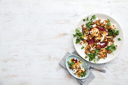 Harissa-roasted cauliflower with beetroot dip, yoghurt and candied walnuts