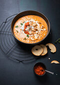 Vegan bell pepper and potato soup with ajvar and garlic bread chips