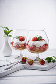 Vegan strawberry tiramisu with yoghurt cream in glasses