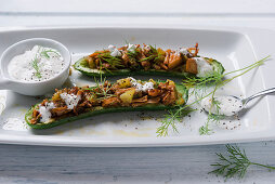 Mini braised cucumbers filled with pulled jackfruit and a vegan dill cream dip