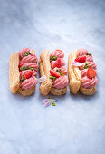 Eclairs with strawberry cream and caramelised pistachio nuts