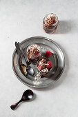 Layered desserts with chocolate cream, pastries, meringue and raspberries
