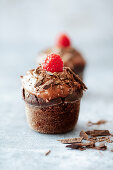 Vegan cupcakes with chocolate, ganache and raspberries