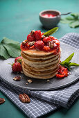 Vegan pancakes with strawberry compote, pecans and mint
