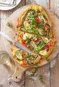 Pizza with eggplant, camembert and arugula