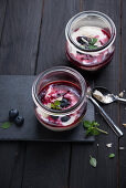 Almond yogurt with blueberry compote in a glass