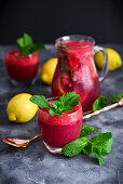 Raspberry lemonade in a jug and a glass