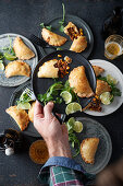 Empanadas with an onion and beef filling, limes and coriander