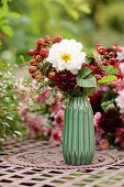 Bouquet of dahlias and unripe blackberries