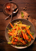 Carrot salad with orange, cinnamon and pine nuts