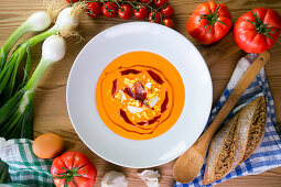 Traditional spanish salmorejo - cold tomato soup served with boiled egg, iberico ham and olive oil