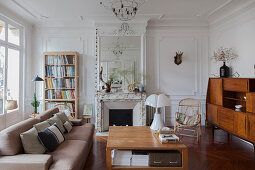 Sofa, coffee table, rattan chair and retro sideboard in living room